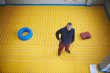 Image showing workers installing underfloor heating system