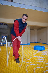 Image showing workers installing underfloor heating system