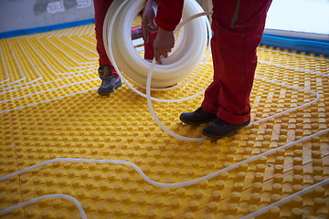 Image showing workers installing underfloor heating system