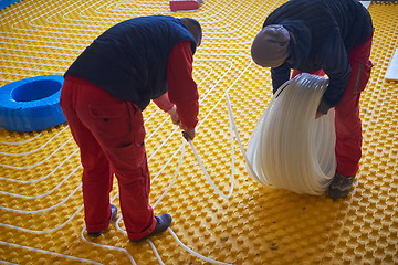 Image showing workers installing underfloor heating system