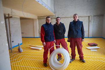 Image showing workers installing underfloor heating system
