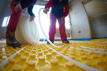 Image showing workers installing underfloor heating system