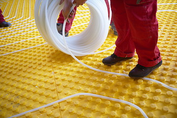 Image showing workers installing underfloor heating system