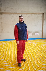 Image showing workers installing underfloor heating system