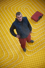 Image showing workers installing underfloor heating system