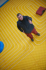 Image showing workers installing underfloor heating system