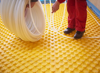 Image showing workers installing underfloor heating system