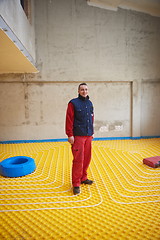 Image showing workers installing underfloor heating system