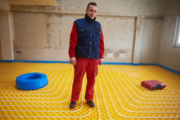 Image showing workers installing underfloor heating system