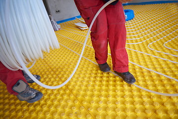 Image showing workers installing underfloor heating system