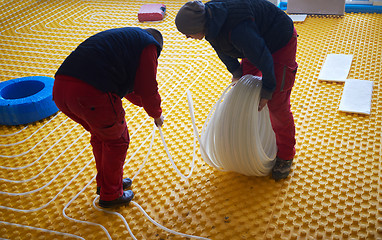 Image showing workers installing underfloor heating system