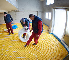 Image showing workers installing underfloor heating system