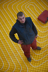 Image showing workers installing underfloor heating system