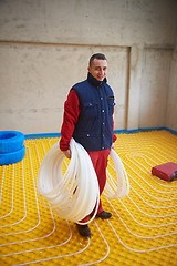 Image showing workers installing underfloor heating system