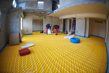 Image showing workers installing underfloor heating system