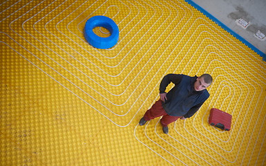 Image showing workers installing underfloor heating system