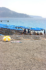 Image showing Beach with blue umbrellas