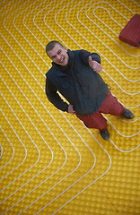 Image showing workers installing underfloor heating system