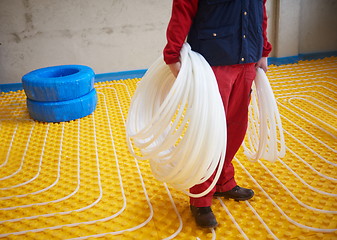 Image showing workers installing underfloor heating system