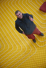 Image showing workers installing underfloor heating system