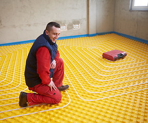 Image showing workers installing underfloor heating system