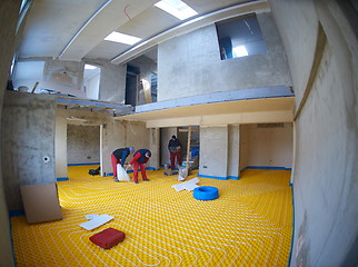 Image showing workers installing underfloor heating system