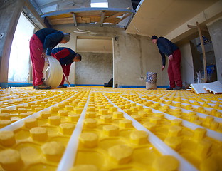 Image showing workers installing underfloor heating system