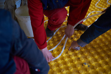 Image showing workers installing underfloor heating system