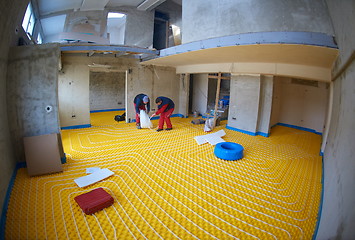 Image showing workers installing underfloor heating system