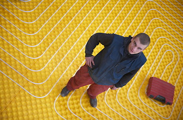 Image showing workers installing underfloor heating system