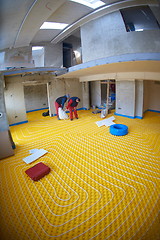 Image showing workers installing underfloor heating system