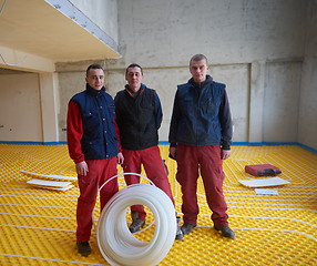 Image showing workers installing underfloor heating system