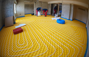 Image showing workers installing underfloor heating system