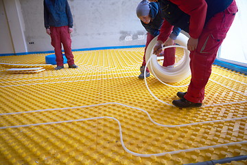 Image showing workers installing underfloor heating system