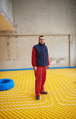 Image showing workers installing underfloor heating system