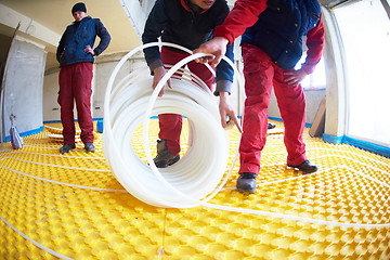 Image showing workers installing underfloor heating system