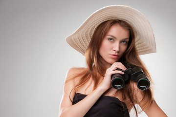 Image showing Young woman in hat with binoculars