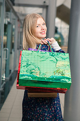 Image showing beautiful young woman with a shopping bags in the mall