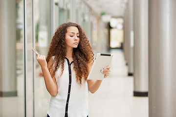 Image showing Beautiful young girl paying by credit card for shopping 