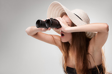 Image showing Young woman in hat with binoculars