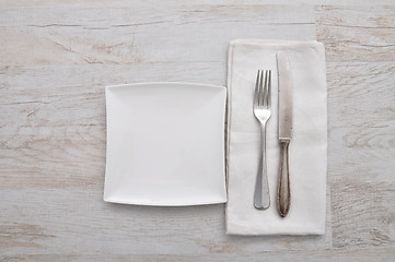 Image showing Plate, cutlery and cloth on wood