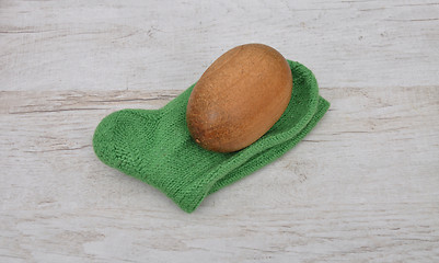 Image showing Darning egg and hand-knitted sock