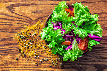 Image showing Fresh salade on wooden background