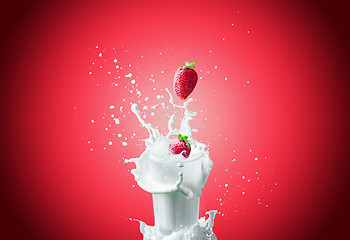 Image showing Strawberries falls in milk 