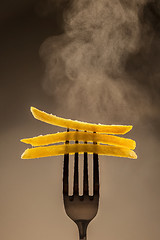 Image showing French fries on a fork