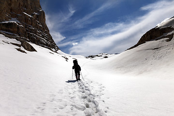 Image showing Silhouette of hiker on snow plateau