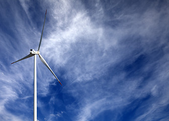 Image showing Wind turbine and blue sky with clouds