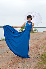 Image showing Smiling girl with an umbrella