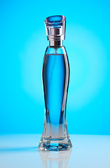 Image showing Women\'s perfume bottle on a blue background