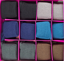 Image showing Warm socks rolled up in a box.